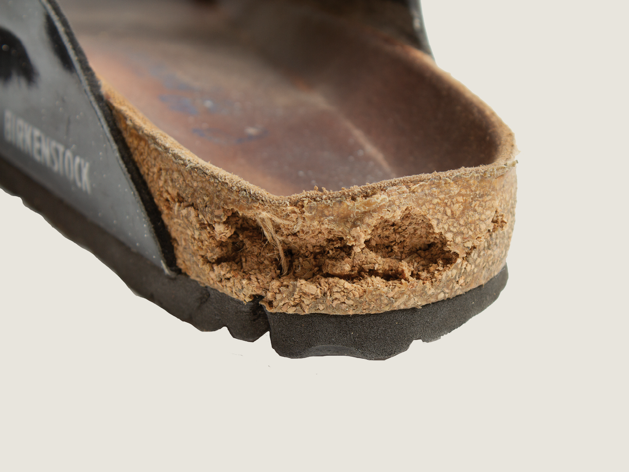 Birkenstock with damaged heel cork requiring repair.